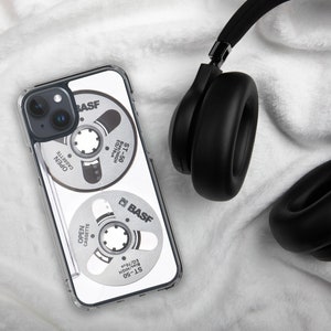 May include: A clear phone case with a design of two vintage cassette tapes. The tapes are labeled "BASF ST-50" and feature the text "OPEN CASSETTE" and "Bias/HIGH EQ/70us".