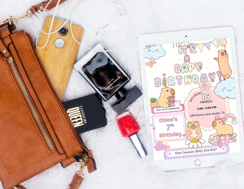 May include: A flat lay featuring a brown leather purse, a wooden-backed phone, a black perfume bottle, a black compact, and a red nail polish bottle. A tablet displays a birthday invitation with capybara illustrations and the text "It's a Capy Birthday!"