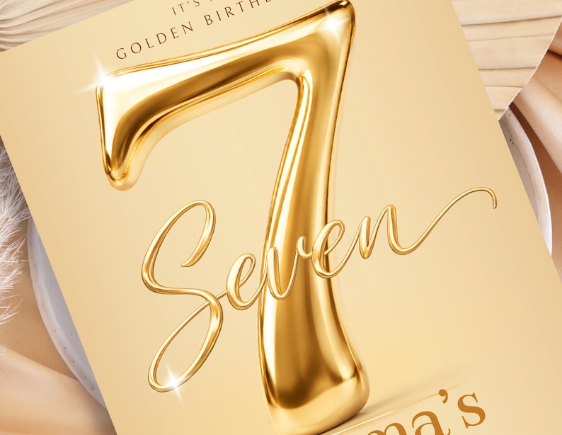 May include: A rectangular card featuring a large, three-dimensional metallic gold number seven. Below the number, the word Seven is written in a flowing, elegant script font. The text IT'S A GOLDEN BIRTHDAY appears at the top, and a partial name ends in 's'.
