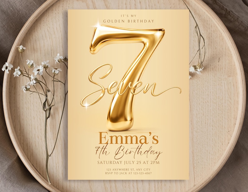 May include: A rectangular birthday invitation card featuring a large, metallic gold 3D number seven and the text IT'S MY GOLDEN BIRTHDAY, Seven, Emma's 7th Birthday, SATURDAY JULY 25 AT 2PM, 123 ANYWHERE ST, ANY CITY, RSVP TO JACK AT 123-123-4567.