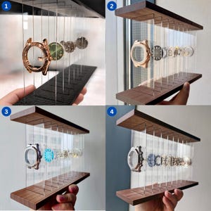 Könnte beinhalten: Ein Uhrenständer mit einer Reihe vertikaler, transparenter Acrylplatten, die zwischen zwei horizontalen Holz- oder Carbonfaserplatten befestigt sind. Der Ständer hält zerlegte Uhrenkomponenten wie Gehäuse, Zifferblätter und Uhrwerke in einer Reihe.