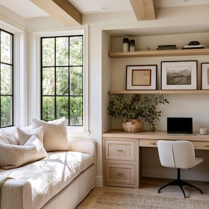 May include: A light-filled home office with a neutral color palette. Features include a built-in desk with drawers, a laptop, and a comfortable chair. A sofa with pillows sits near large windows with black frames. Decorative shelves and framed artwork complete the space.