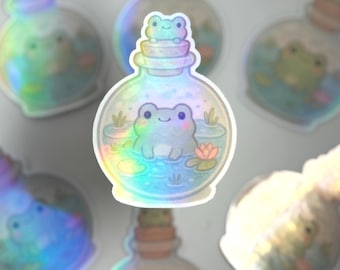May include: A set of iridescent holographic stickers featuring frogs in glass bottles. The stickers are perfect for adding a whimsical touch to journals, laptops, water bottles, and more.