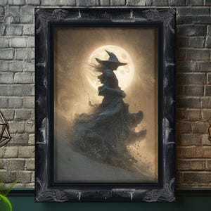 May include: A framed artwork depicts a silhouetted witch with a pointed hat and flowing gown against a full moon. The artwork is in a black ornate frame, creating a gothic or fantasy theme. The color palette is primarily dark, with shades of gray and sepia.