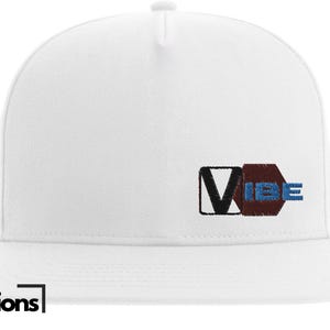 May include: White baseball cap with a black and brown patch that says "VIBE" in blue and white letters.