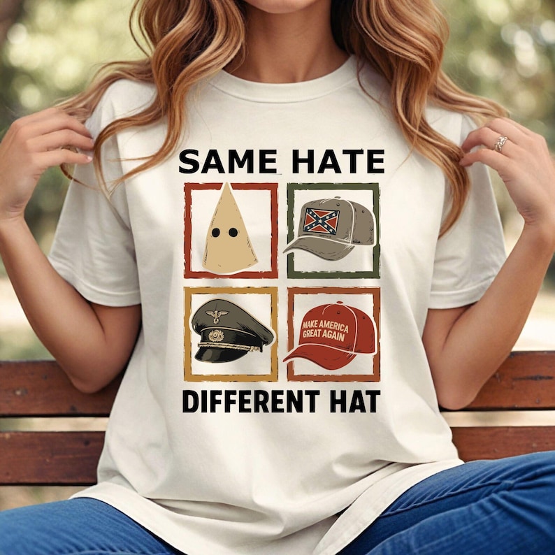 May include: A white t-shirt with the text "SAME HATE DIFFERENT HAT" and four images of different hats. The hats include a white pointed hood, a baseball cap with a Confederate flag, a military cap, and a red baseball cap with the text "MAKE AMERICA GREAT AGAIN."