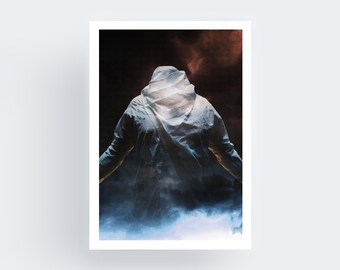 May include: A framed art print featuring a person in a hooded jacket, viewed from the back. The figure is enveloped in a misty, ethereal atmosphere with shades of blue, white, and brown. The artwork evokes a sense of mystery and introspection.