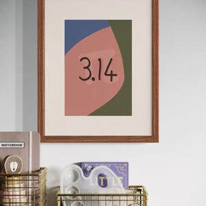May include: A framed print with a geometric abstract design in shades of pink, green, and blue. The number 3.14 is written in black on the pink section.