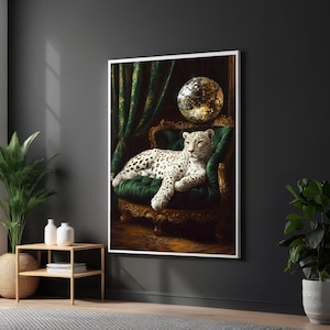 May include: A framed art print depicting a leopard reclining on a green velvet chair. A disco ball is in the background, with green curtains. The leopard has black spots and is set against a dark backdrop.