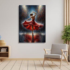 May include: A canvas print shows a dancer in a flowing red dress, captured mid-performance. The artwork uses an impressionistic style with a backdrop of rain and light, creating a dynamic scene. The dancer's reflection is visible in the water, adding depth to the image.