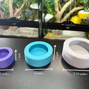 May include: Three round, shallow bowls in different sizes and colors. The smallest bowl is purple and measures 2.25 inches in diameter. The middle bowl is blue and measures 3 inches in diameter. The largest bowl is white and measures 3.75 inches in diameter.