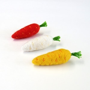 Miniature needle felted carrot brooches. Set of 3. Orange, white, yellow carrots. The carrot are needle felted with 100% merino wool with cotton thread embroidered. The carrots have green cotton thread tops.