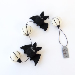 2 black needle felted miniature bats with 3 white needle felted miniature pumpkin garland. Short garland for a small tree and space.