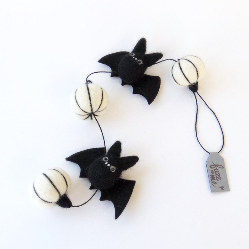 2 black needle felted miniature bats with 3 white needle felted miniature pumpkin garland. Short garland for a small tree and space.