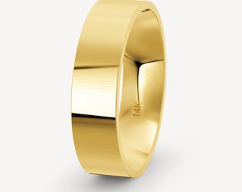 May include: A simple gold band ring with a 14K marking on the inside.