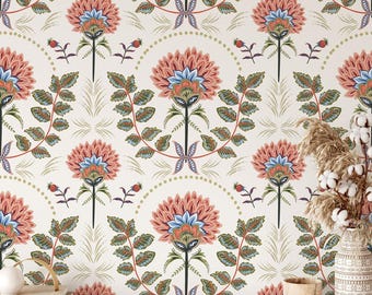 May include: A seamless wallpaper pattern featuring a repeating design of stylized pink and blue flowers with green leaves on a white background.