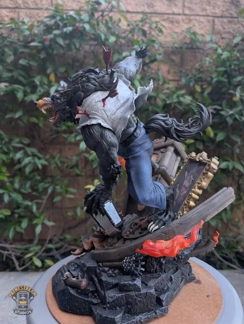 May include: A detailed werewolf figurine with dark fur, wearing a torn white shirt and blue jeans, featuring arrows embedded in the back. The figure stands on a debris-filled base with a broken picture frame and orange flames, marked with a Paynestream Studios logo.
