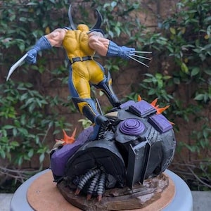 May include: A Wolverine action figure in a dynamic pose, clad in a yellow and blue costume, with claws extended. The figure stands atop a detailed, dark-colored base with purple and orange accents. The base has the text "PAYNESTREAM STUDIOS".