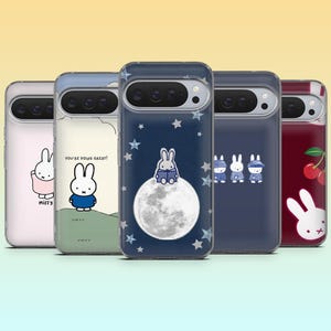 May include: A selection of phone cases with cartoon bunny illustrations. Designs include a bunny reading on the moon, bunnies in hats, and a bunny with the text "You're doing great!" The cases have a clear border.