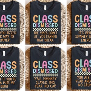 May include: Black t-shirts with the words "CLASS DISMISSED" in colorful letters. Each shirt has a different phrase below the main text, such as "NGL. YOU RIZZED YOUR WAY TO SUMMER" and "YOU ATE THIS YEAR AND LEFT NO CRUMBS."