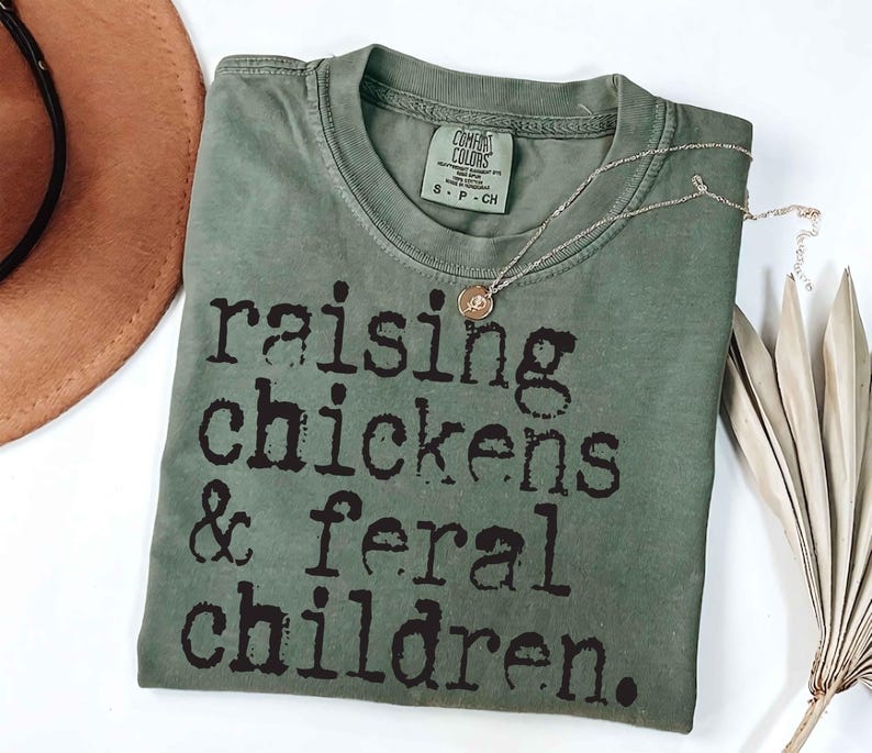 Funny rustic motherhood sublimation design with chickens and playful text “Raising Chickens & Feral Children” in a vintage farm style