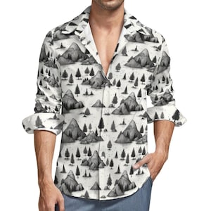 May include: A white long-sleeve button-down shirt with a black and white print of mountains and trees.