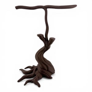 May include: A dark brown jewelry display stand shaped like a tree with exposed roots at the base and a horizontal T-bar branch at the top. The surface features a molded wood grain texture throughout the entire structure, providing a stable base.