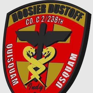 May include: A red, gold, and black military patch with the text "Hoosier Dustoff" and "Co. C 2/238th" in gold lettering. The patch features a black cross with two yellow snakes intertwined, and the text "USQUAM" and "QUISQUAM" on either side of the cross. The patch also includes the text "Indy" and a stylized image of a race car.