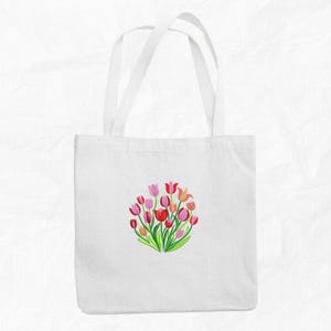 May include: White tote bag with a colorful floral design featuring pink, red, and white tulips. The design is centered on the bag.