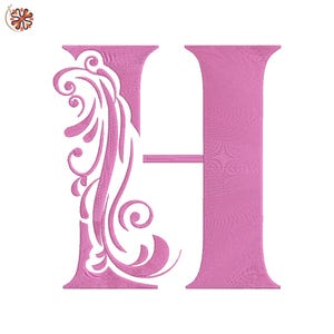 May include: A pink embroidered letter "H" with a decorative floral design on the left side. The letter is in a serif font and the embroidery has a textured appearance. The background is plain white.