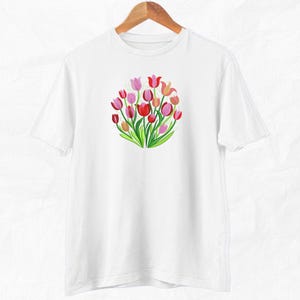 May include: White t-shirt with a colorful graphic of a bouquet of tulips.