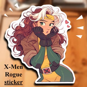 May include: A sticker featuring a cartoon illustration of Rogue from the X-Men. She has long brown and white hair, green eyes, and is wearing a brown jacket, green and yellow costume, and black gloves. She is looking to the right and has a surprised expression on her face.