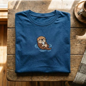 Embroidered Otter T-Shirt, Cute Sea Otter Holding Shell Tee, Marine Animal Lover Gift, River Otter Shirt, Floating Otter Embroidery