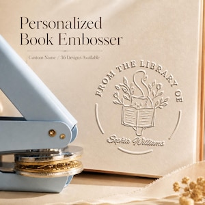 May include: A light blue personalized book embosser with a gold and silver die, next to a cream-colored book cover. The cover is embossed with the words "From The Library Of" and a name. Text on the image reads "Personalized Book Embosser".