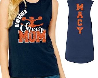 May include: Navy blue sleeveless shirt with the text "Cheer Mom" and "Renegades" in orange glitter. The back of the shirt has the name "MACCY" in orange glitter.
