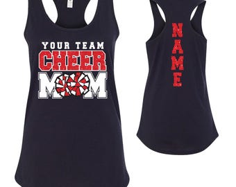 May include: Navy blue tank top with the text "Your Team Cheer Mom" in white with a red glitter pom-pom graphic. The back of the tank top has the word "NAME" in red glitter.
