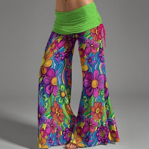 May include: Colorful, wide-leg pants with a vibrant floral pattern in shades of purple, orange, yellow, and blue. The pants have a green waistband with a pink drawstring. The flared design and bold colors create a retro, bohemian aesthetic.
