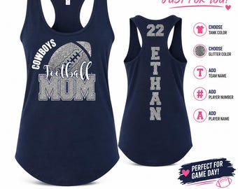 May include: A navy blue racerback tank top featuring a silver glitter graphic on the front that reads COWBOYS Football MOM with a football icon. The back displays the number 22 and the name ETHAN in silver glitter text. Includes customisation icons.