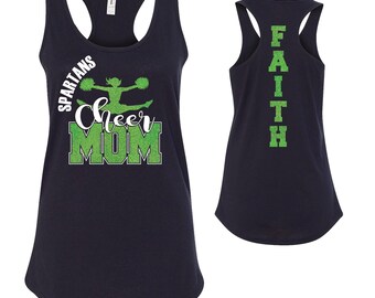 May include: Navy blue tank top with a green glitter design. The front of the tank top says "SPARTANS Cheer MOM" with a cheerleader silhouette. The back of the tank top says "FAITH" in green glitter.
