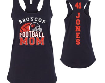May include: Navy blue racerback vest featuring the text "BRONCOS FOOTBALL MOM" in white and red, with a football and helmet graphic. The back displays the number "41" and the name "JONES" in red.