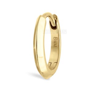 May include: A single gold-coloured hoop earring. The earring has a simple, rounded design with a clasp closure. The text "8mm" is visible on the side. The earring is set against a white background.