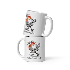 May include: Two white ceramic mugs with a black and white illustration of a stick figure carrying a burning computer. The text on the mug reads "Another Monday in IT".