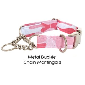Pode incluir: Coleira de c&atilde;o de camuflagem rosa com uma fivela de metal prateada e uma martingala de corrente. Fivela de Metal Corrente Martingala.