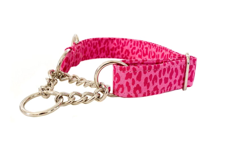 Puede incluir: Collar de perro de estampado de leopardo rosa y blanco con una cadena plateada.