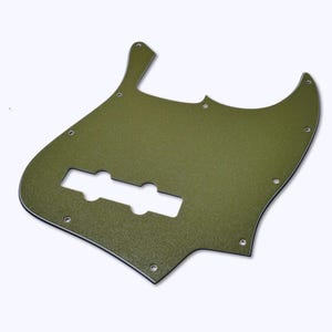 May include: An olive green bass guitar pickguard with a textured finish. It features a rectangular cutout for pickups and several screw holes. The edges are smooth, and the overall shape is asymmetrical. The pickguard is designed to protect the guitar's body.