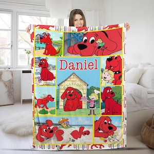 May include: A white fleece blanket featuring a collage of Clifford the Big Red Dog illustrations. The blanket has a yellow grid pattern with images of Clifford in various scenes, and the name "Daniel" is displayed in red text.