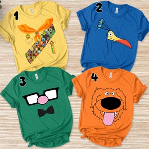May include: Four colorful graphic t-shirts. A yellow shirt with a scout uniform design, a blue shirt with a bird graphic, a green shirt with glasses and a bow tie, and an orange shirt with a dog graphic.