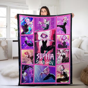 May include: A black and white Spider-Gwen blanket with a pink border. The blanket features comic-style panels of Spider-Gwen in various action poses. The name "Sophia" is prominently displayed, along with "Spider-Gwen".