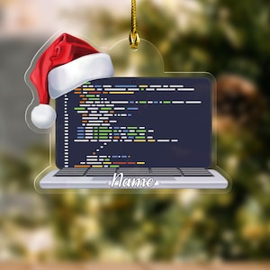 May include: A clear, laptop-shaped Christmas ornament with a Santa hat. The laptop screen displays colorful code, and the word "Name" is written on the bottom. A gold string is attached for hanging.