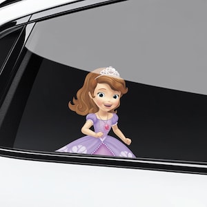 May include: A car window decal featuring a cartoon princess with brown hair, wearing a purple dress and a tiara. The princess has a smiling expression and a pink heart-shaped pendant.